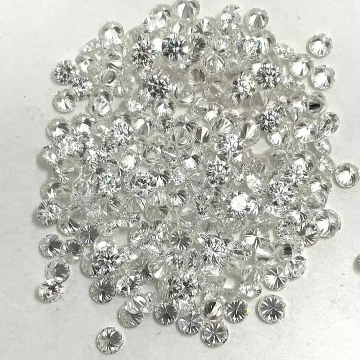 Pile of loose round brilliant diamonds with bright faceted sparkle