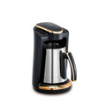 Korkmaz black and stainless steel Turkish coffee maker with modern gold trim accents on a white background.