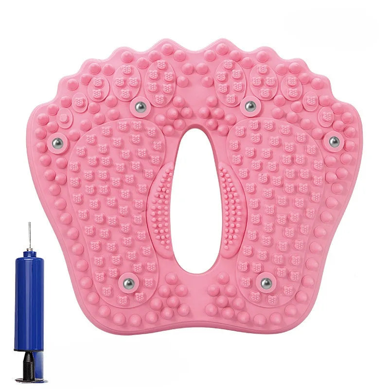 Pink, foot-shaped inflatable massage mat with magnetic acupoint studs and a blue hand pump.