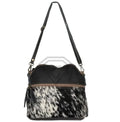 Luxury handmade crossbody bag in black leather and white-black cowhide hair-on print with adjustable shoulder strap.