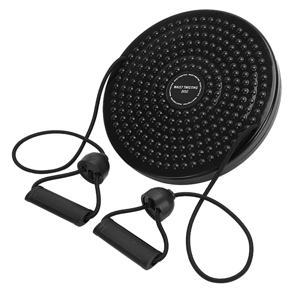 Black circular waist twisting disc with textured surface and attached resistance bands with handles for exercise.