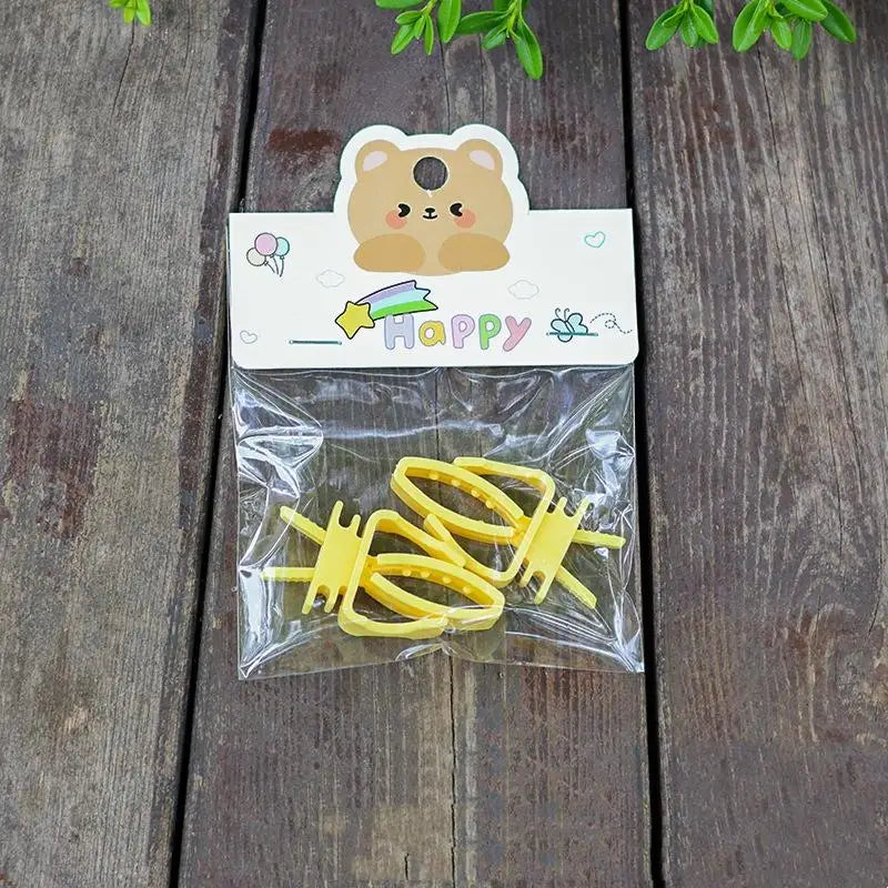 Yellow plastic bird cage food clips for feeding parrot fruits, vegetables, and cuttlefish bone securely.