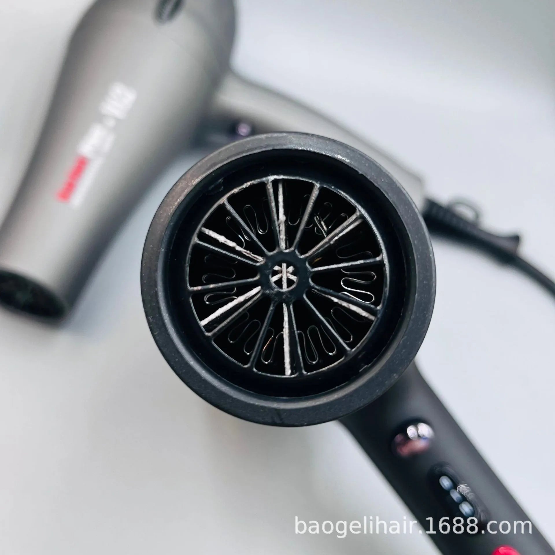 Professional 2600W grey salon hair dryer with high-speed motor and ergonomic heat control buttons for quick drying.