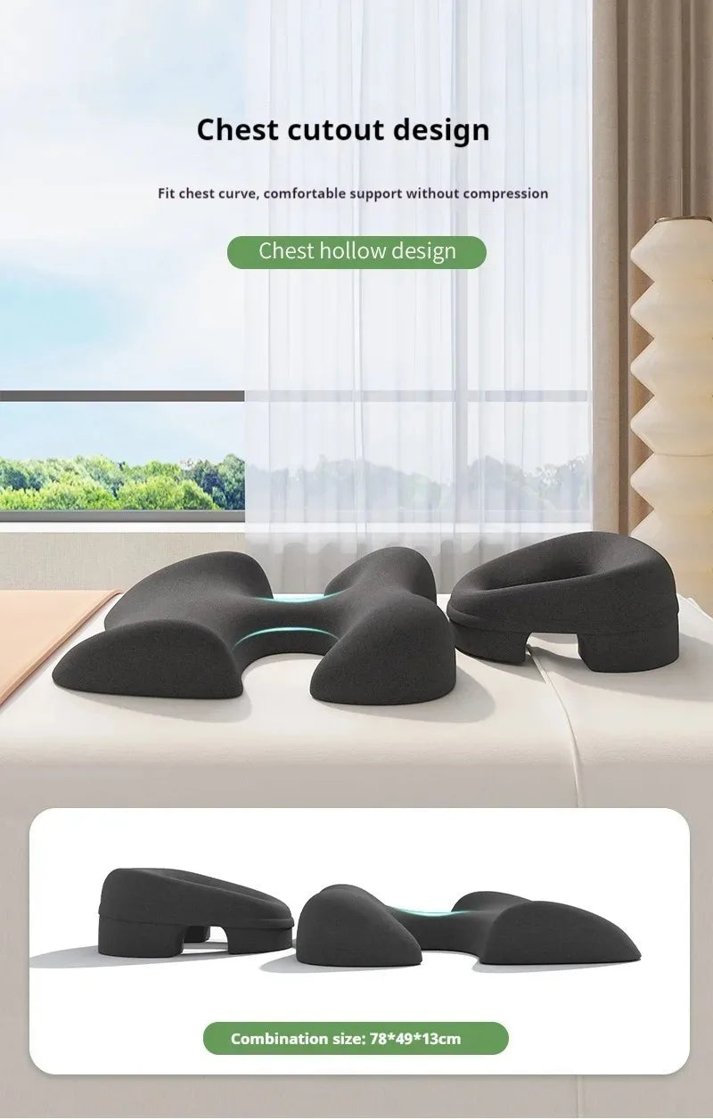 Dark gray ergonomic massage cushion set with a chest cutout, designed for prone comfort during spa treatments.