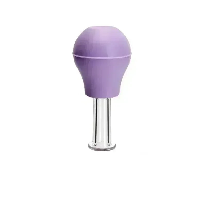 A light purple rubber squeeze bulb attached to a clear, cylindrical glass facial massage cupping tool.