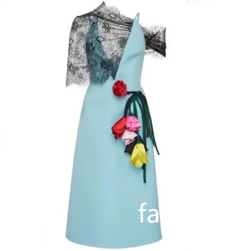 Light blue A-line midi dress with one-shoulder black lace overlay and colorful floral embellishments at the waist.