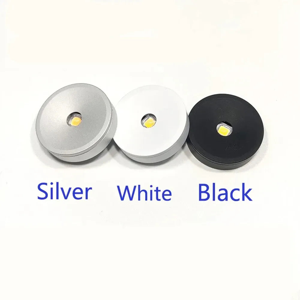 Set of recessed puck lights in silver, white, and black with LED lenses