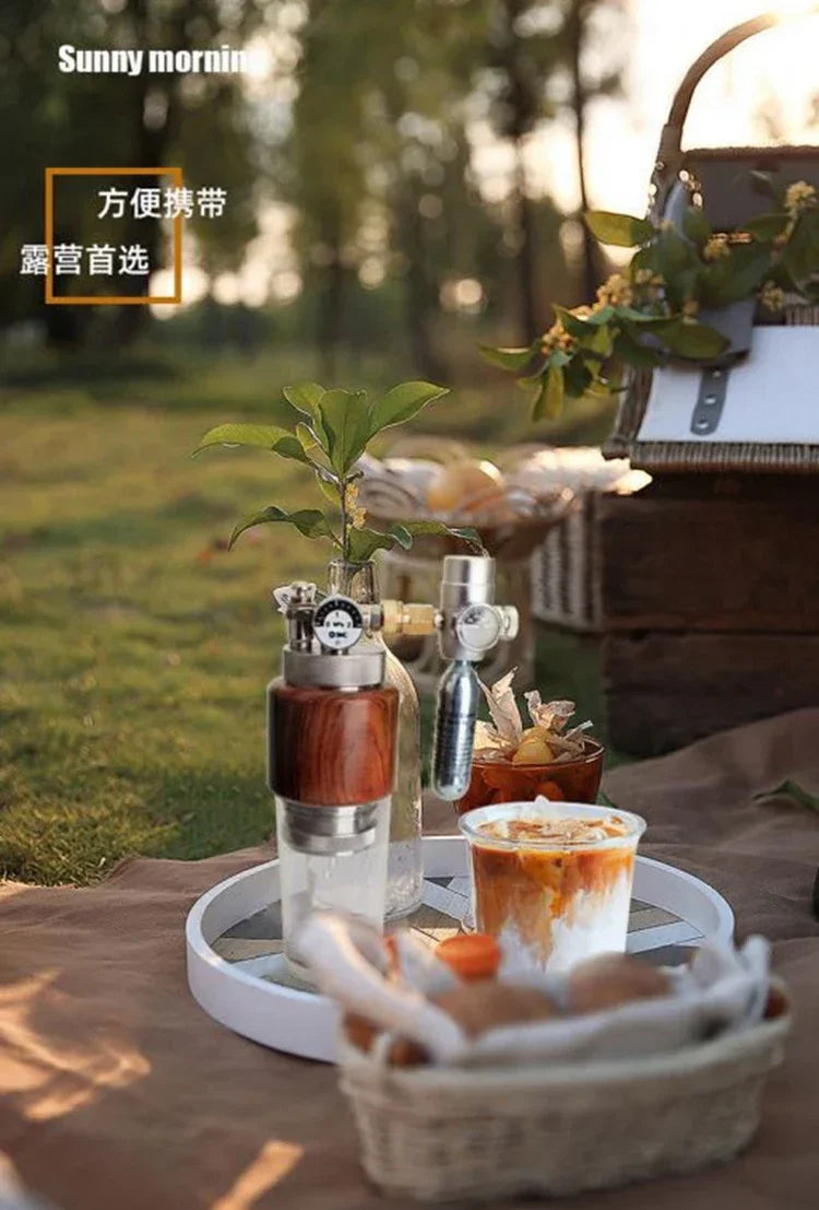 Portable stainless steel and wood espresso maker with pressure gauge for outdoor camping coffee brewing.