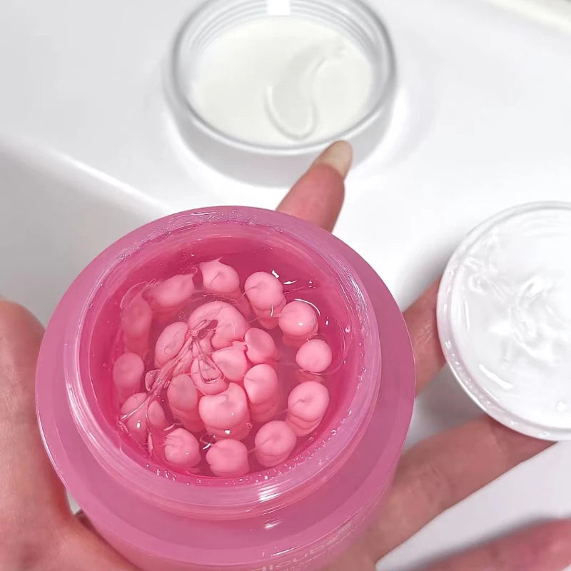 Open pink jar containing small pink collagen capsules suspended in a clear, lightweight gel moisturizer.