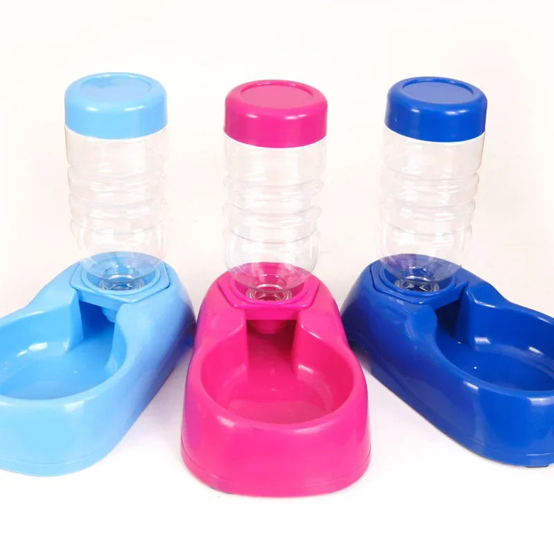 Three automatic pet water dispensers in blue and pink for cats and dogs with convenient refillable water bottles.