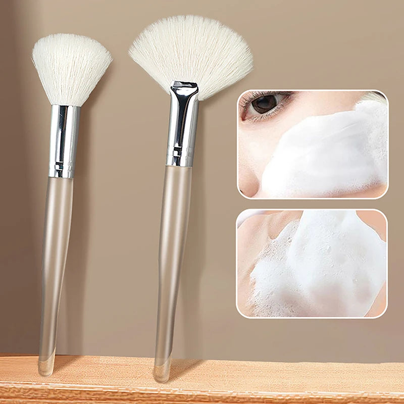 Soft facial cleansing and mask brushes with clear handles and white bristles for gentle skincare application.