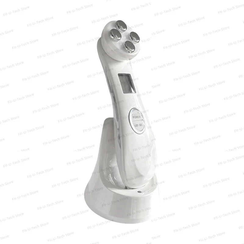 White handheld facial massager with a four-metal-probe head and charging stand, featuring a digital display and buttons.