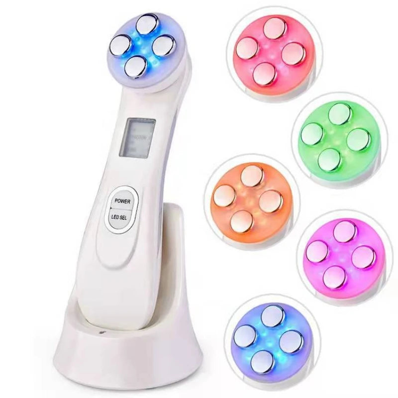 White handheld LED facial skin tightening device with four metal massage heads, digital display, and charging base.