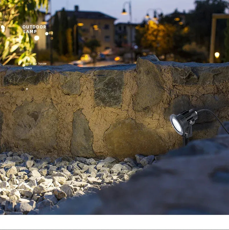 Outdoor LED landscape spike spot light with black round head on ground stake