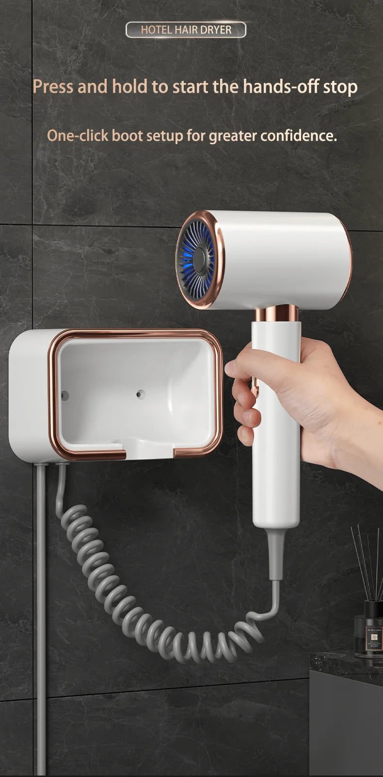 White and rose gold wall-mounted hairdryer with coiled cord, hands-free holder, and high-power hotel design.