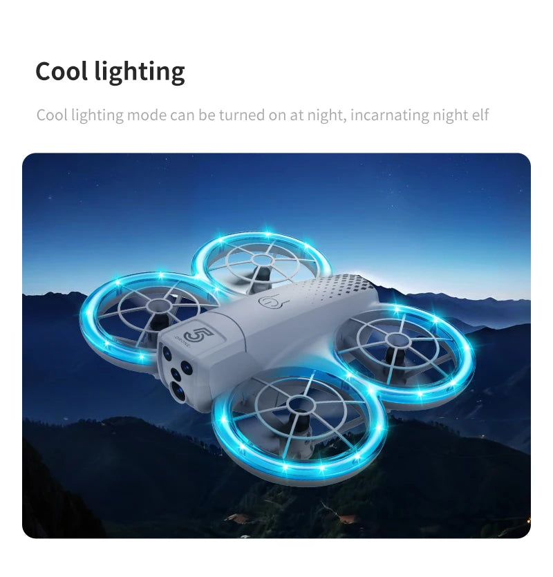 Small white quadcopter drone with four glowing blue LED propeller guards, hovering against a dark mountain backdrop.