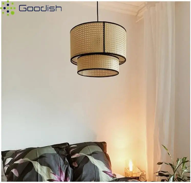 Two-tier cylindrical pendant light made of natural beige woven rattan with black metal trim for indoor ceiling lighting.