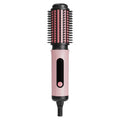 Pink TINSOL negative ion hot air brush for styling, curling, and straightening hair with rounded bristle design.
