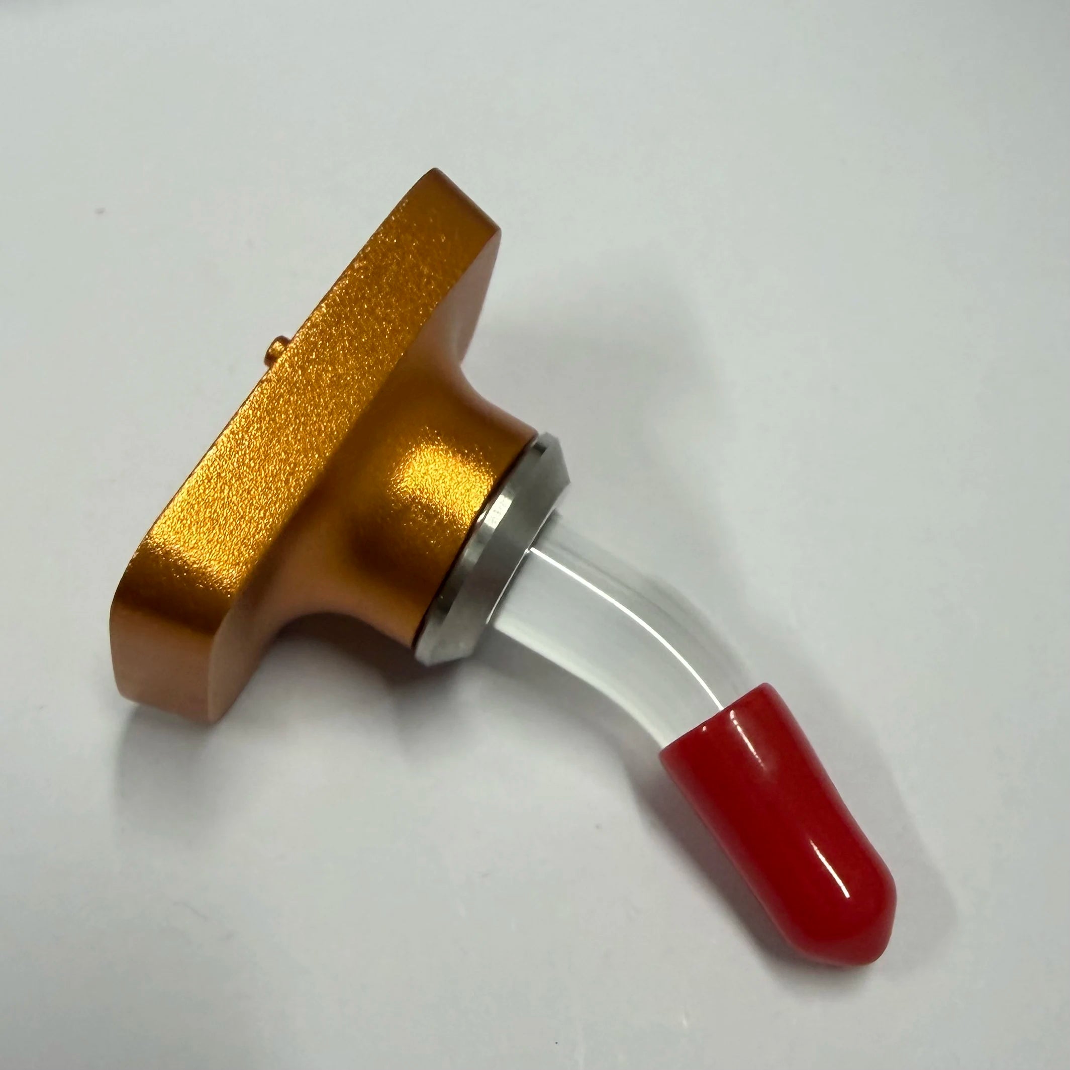 Gold metal handle tool with red end grip and silver collar