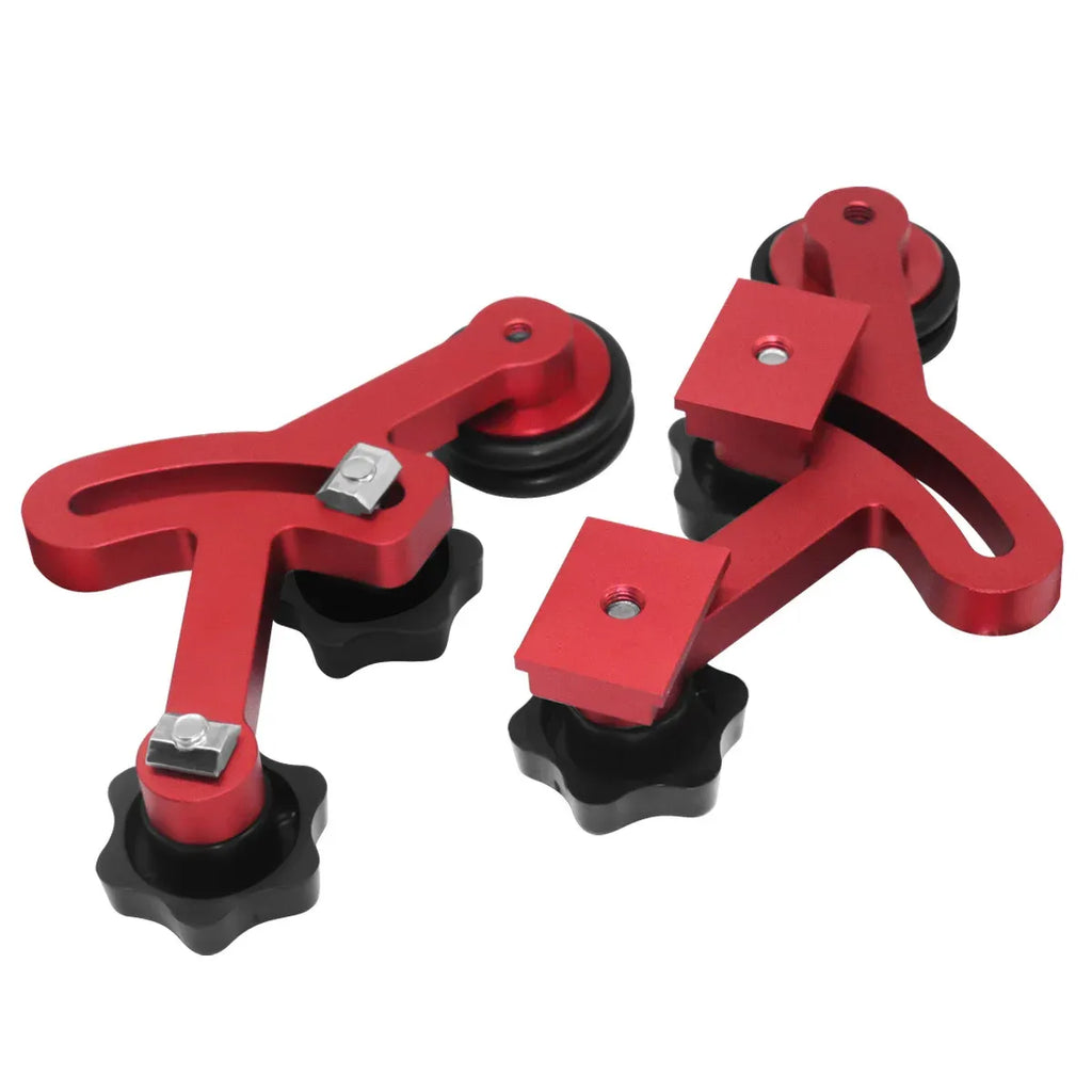 Set of red and black woodworking stock guides with roller bearings and threaded mounts