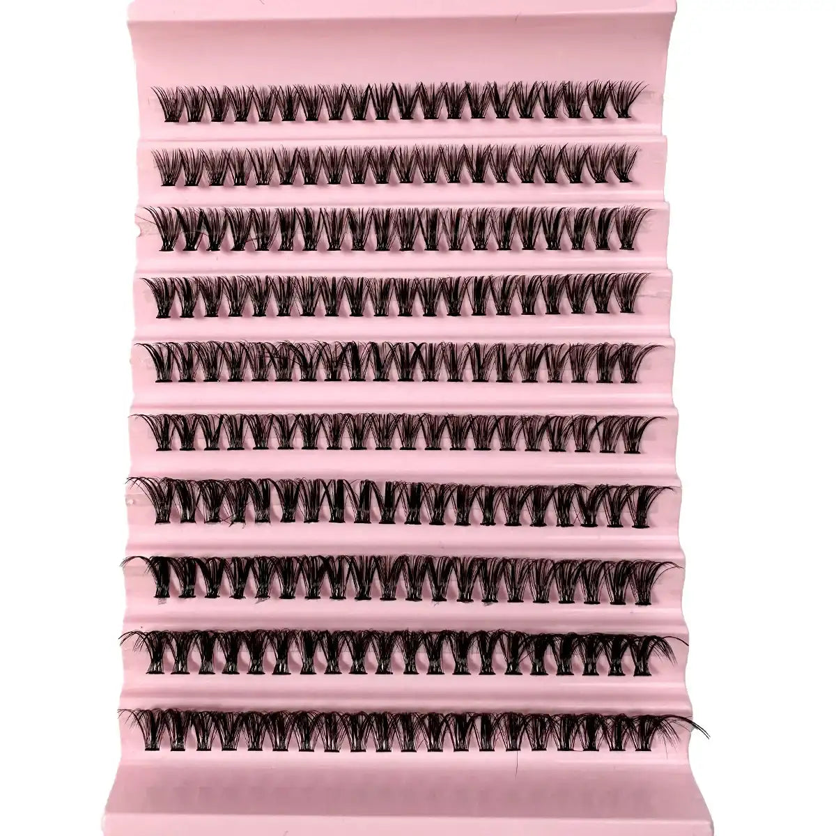 Black cluster eyelashes arranged on a light pink plastic tray for professional lash extension application.