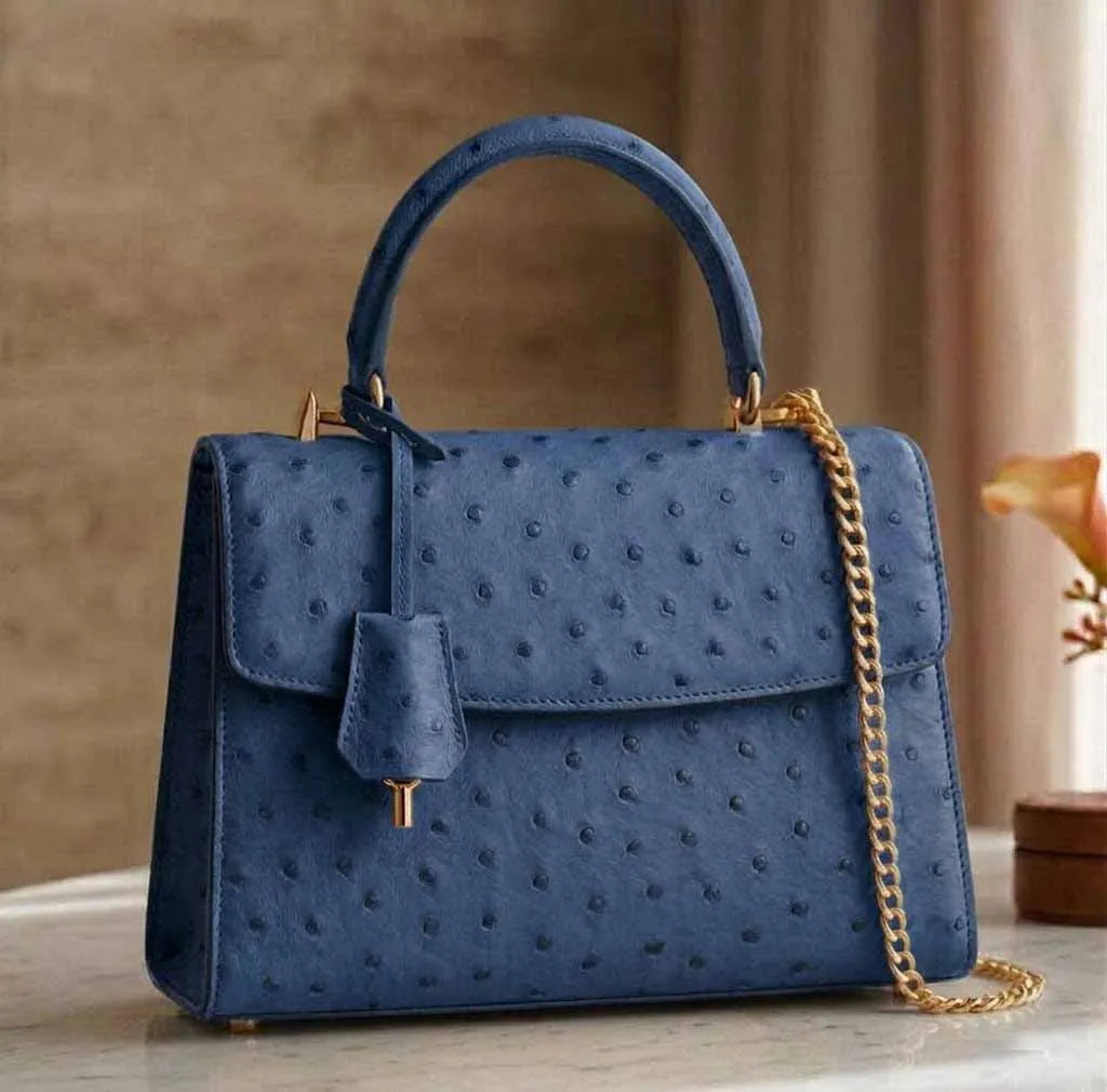 Blue genuine ostrich leather vintage designer handbag with gold chain strap, top handle, and classic flap closure.