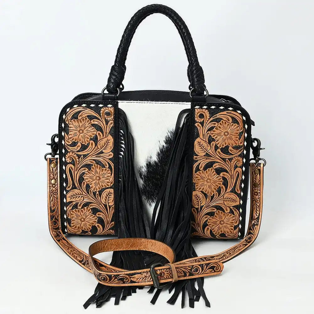 Handmade luxury genuine leather western weekender bag with floral tooling, black fringe, and cowhide center panel.