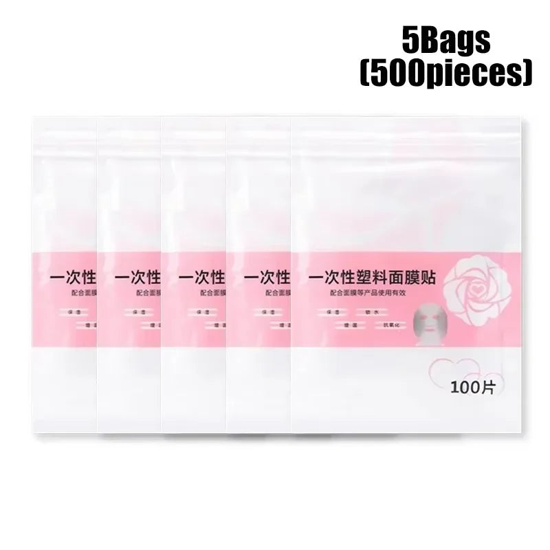 Five bags of 100 disposable clear plastic face mask sheets, each in white packaging with pink accents and rose logo.