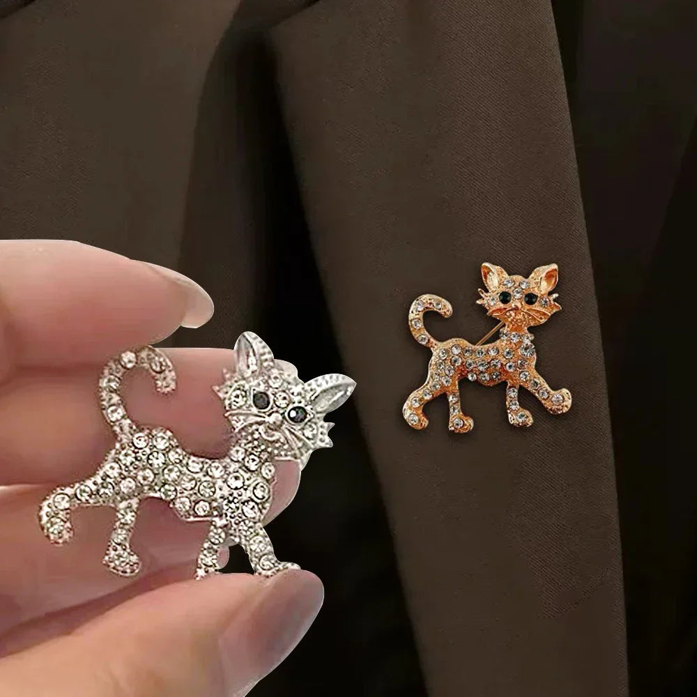 Sparkling crystal cat brooch pins in gold and silver, perfect gift jewelry for cat lovers to accessorize coats or bags.