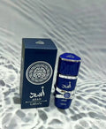 Lattafa Asad EDP for men, cylindrical blue bottle with silver detail, long-lasting oriental fragrance spray.
