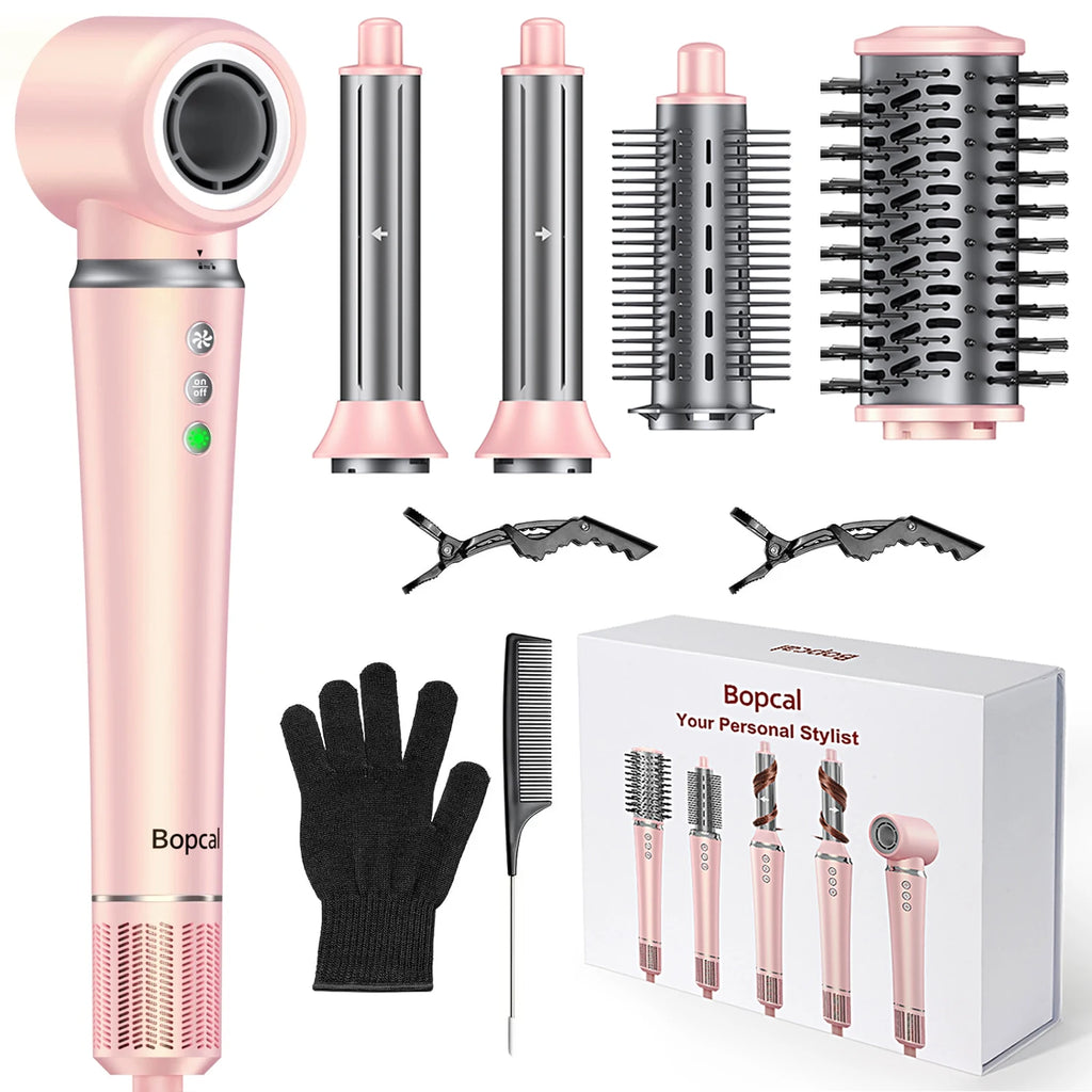 Pink 5-in-1 air wrap hair styler set with dryer, curlers, brushes, clips, and glove for frizz-free hair styling.