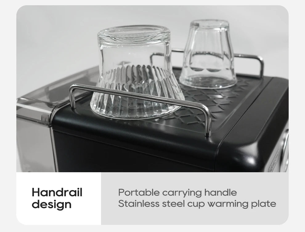 Black espresso machine with stainless steel cup warming plate and protective handrail for two glass espresso cups.