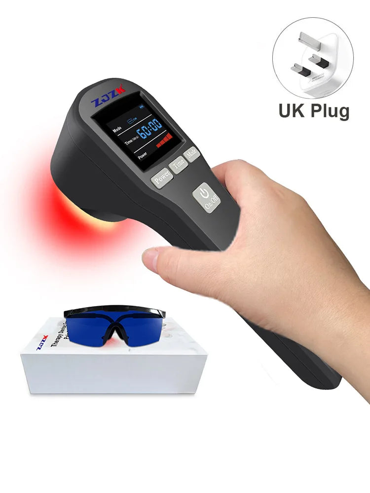 Handheld red light therapy device, black plastic, with digital display, protective glasses, and a UK plug adapter.