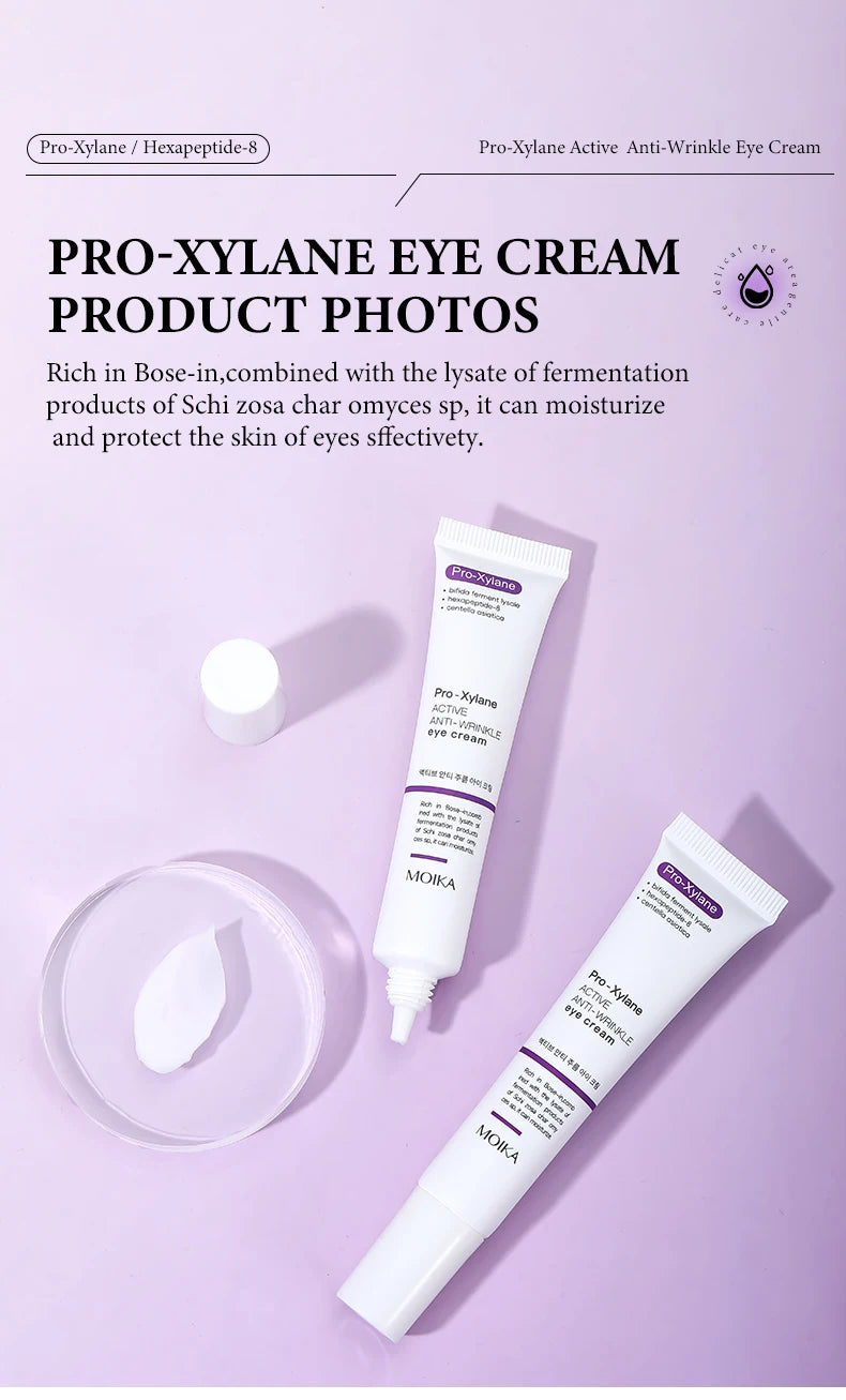 Pro-Xylane anti-wrinkle eye cream tubes with smooth white cream texture on a lavender background.