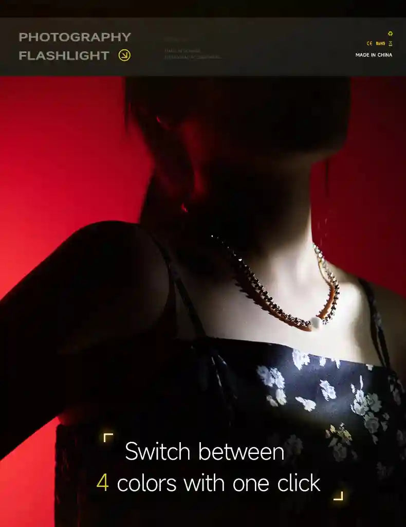 Photography flashlight illuminating a person’s necklace against a vibrant red background.