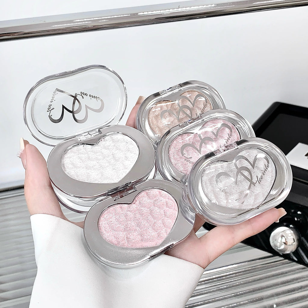 Tidesmit LEE INTO highlighter powder texture close-up featuring fine pearlescent shimmer and silky mashed potato finish