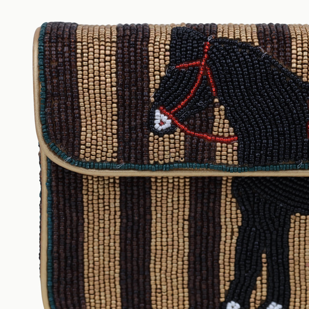 Bohemian beaded shoulder bag featuring a black horse pattern on brown and gold striped fabric. Designer handbag.