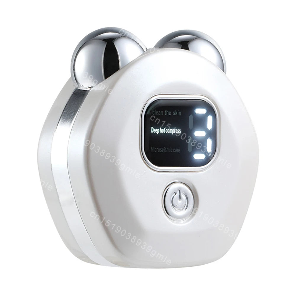 White, rounded facial massager with two silver rollers on top, a digital display, and a power button on the front.
