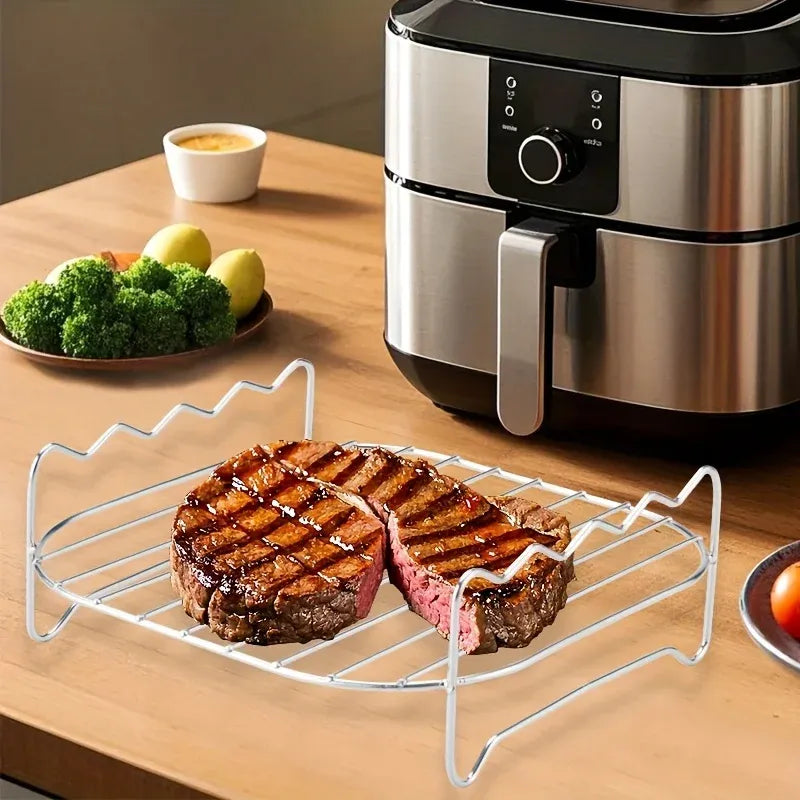 Air fryer grill rack with skewers holding grilled steak pieces on tabletop