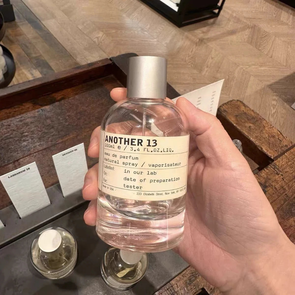 Le Labo Another 13 Eau de Parfum, 3.4oz spray. Unisex perfume in a minimalist round glass bottle. Luxury holiday gift.