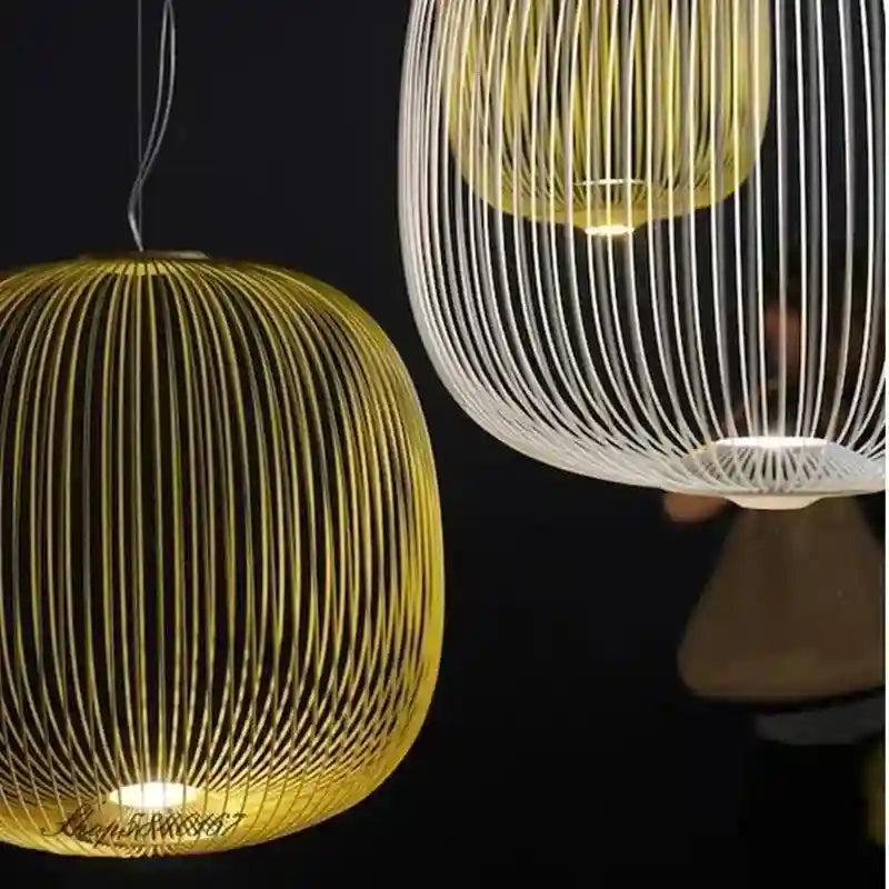 Round cage pendant lights with thin yellow and white metal wires for modern interior ceiling illumination.