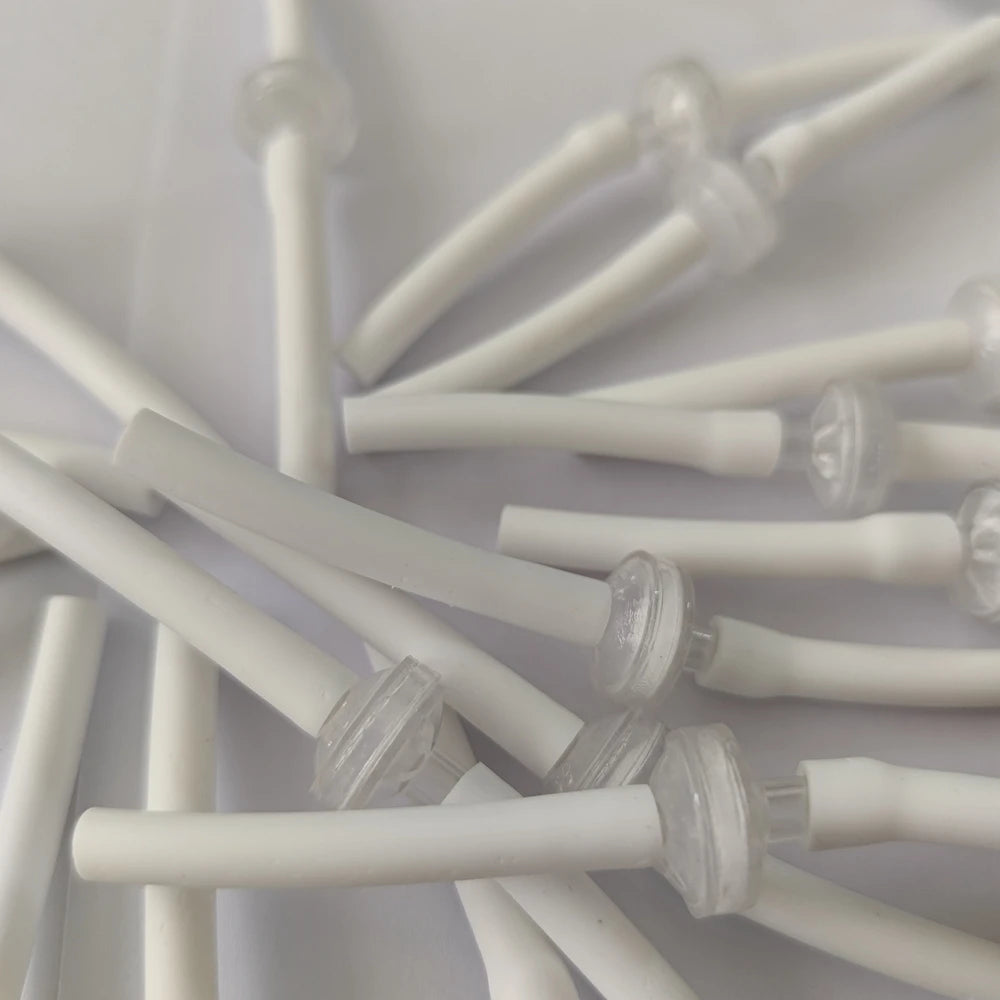 White disposable connection tubes for Microneedle RF cartridge machines, used for skin lifting and scar treatment.