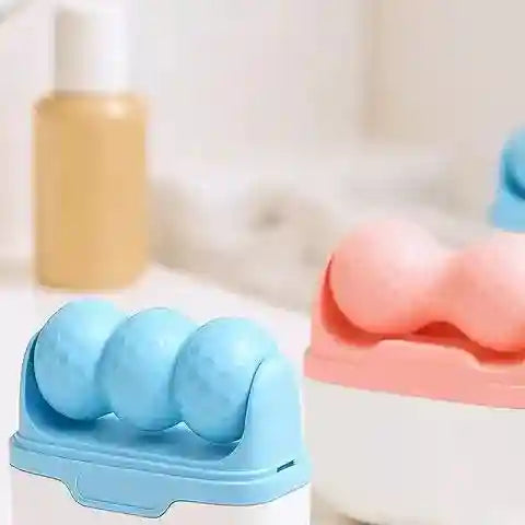 Blue and pink handheld face rollers with dimpled spherical heads on white bases, set against a blurred background.