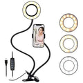 Black clip-on ring light with flexible gooseneck, phone holder, and USB controller for video calls and photography.
