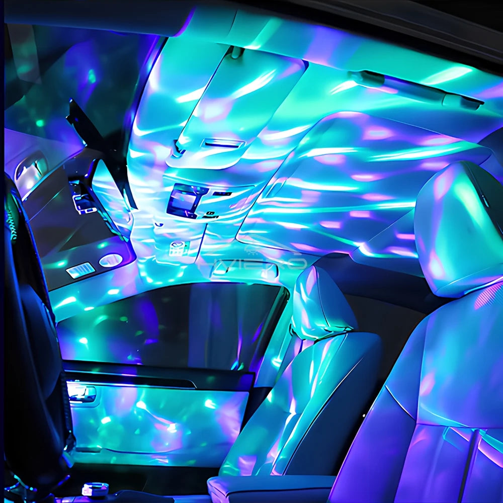Car ceiling light projector casting wave-like blue and purple patterns across a vehicle interior.