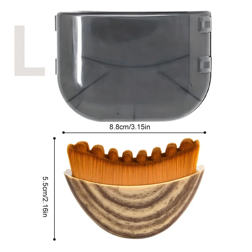 Curved facial massage brush with tan bristles and a patterned handle, shown with its gray storage cover and dimensions.