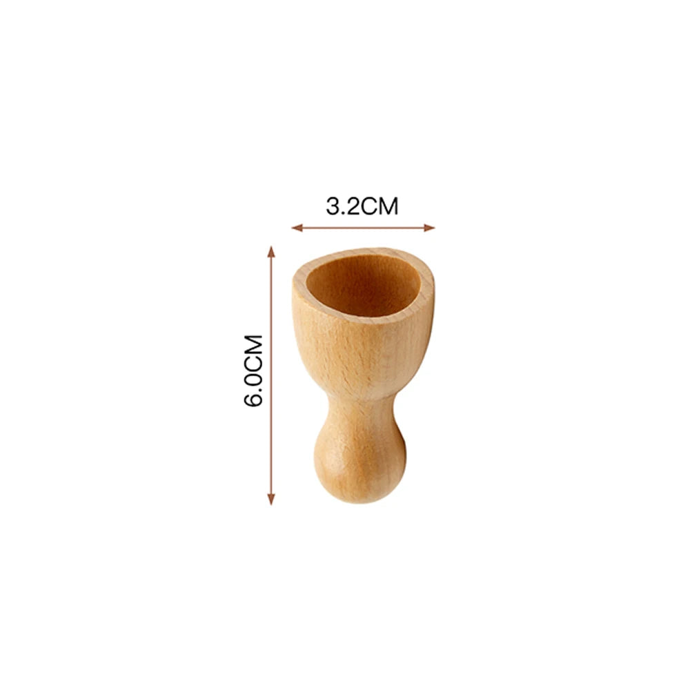 Small, light-wood facial massage cup for Maderoterapia, 6cm tall and 3.2cm wide.