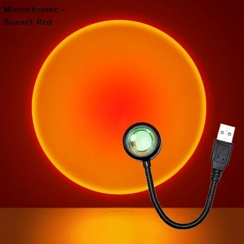 Sunset lamp with black flexible neck and USB plug, projecting a large, glowing red-orange circular light on a wall.