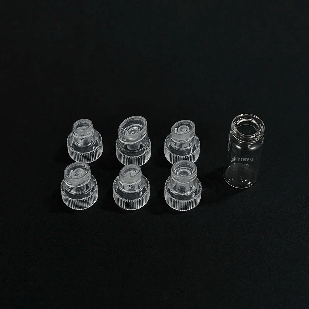 Clear replacement suction tips and glass vial for 7-in-1 hydro facial machine for deep cleansing and skin lifting.