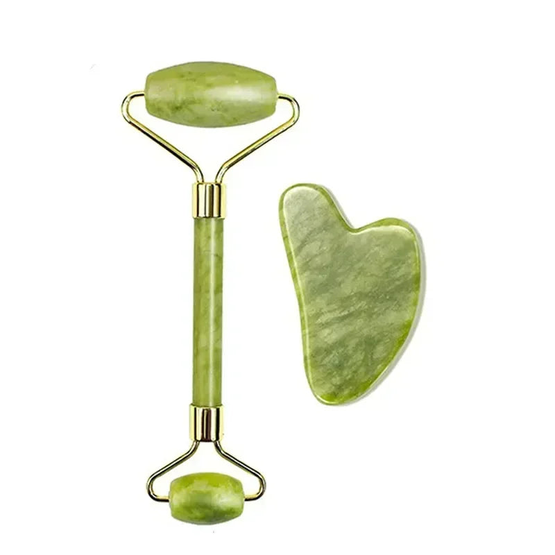 Green jade facial roller and heart-shaped gua sha tool with gold-tone hardware for skincare massage.
